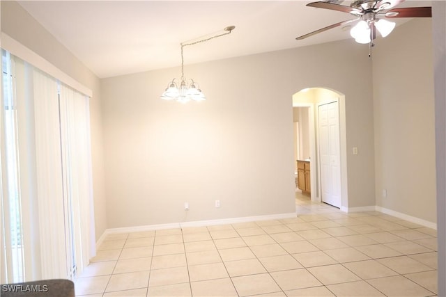 4526/4524 28th St SW, Lehigh Acres, FL 33973 - empty room featuring arched walkways, a ceiling fan, light tile patterned floors, a chandelier, and baseboards
