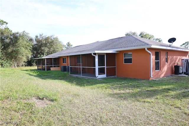 4526/4524 28th St SW, Lehigh Acres, FL 33973 - back of house with a sunroom, a yard, central AC, and stucco siding