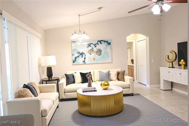 4526/4524 28th St SW, Lehigh Acres, FL 33973 - living room with light tile patterned floors, a ceiling fan, arched walkways, a chandelier, and baseboards