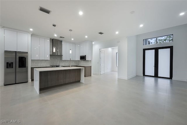 2806-2840 Golden Gate Blvd W, Naples, FL 34117 - kitchen with stainless steel appliances, wall chimney exhaust hood, modern cabinets, white cabinetry, and light countertops