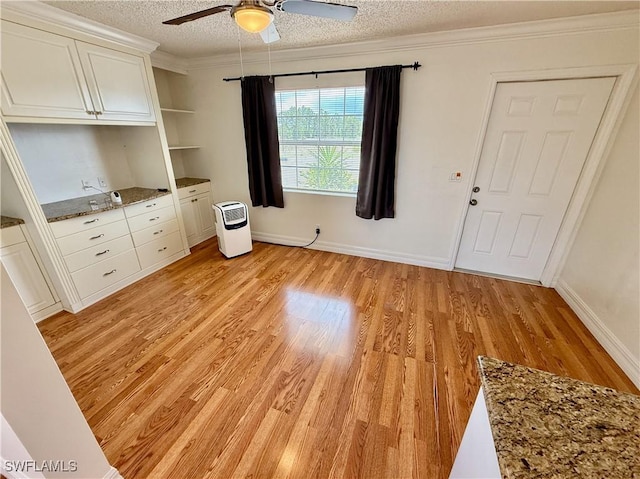 3700 26th St SW, Lehigh Acres, FL 33976 - unfurnished living room with a textured ceiling, ceiling fan, light wood finished floors, ornamental molding, and baseboards