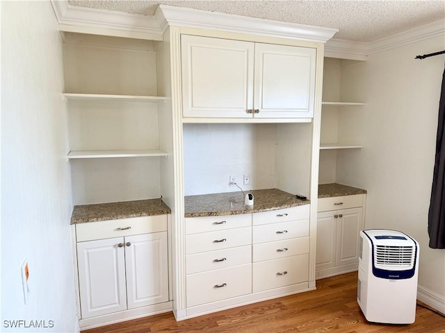 3700 26th St SW, Lehigh Acres, FL 33976 - unfurnished office featuring light wood-style flooring, ornamental molding, and a textured ceiling