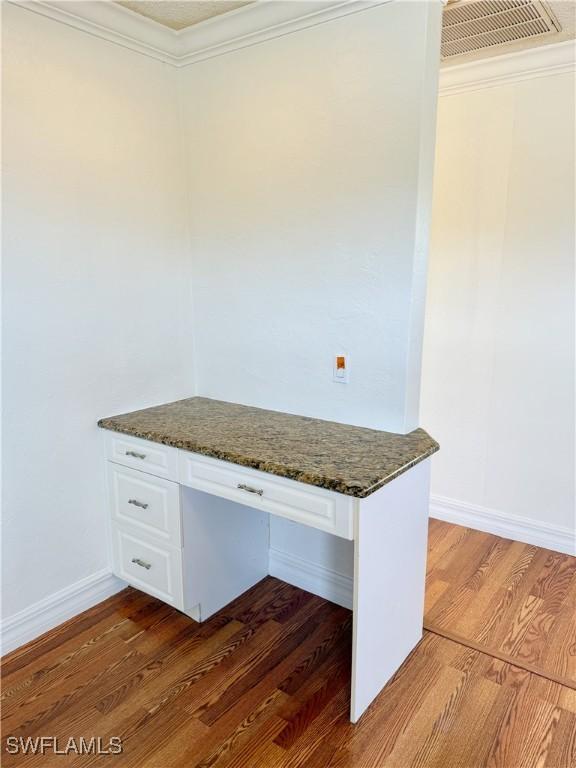 3700 26th St SW, Lehigh Acres, FL 33976 - unfurnished office with wood finished floors, ornamental molding, baseboards, and built in study area