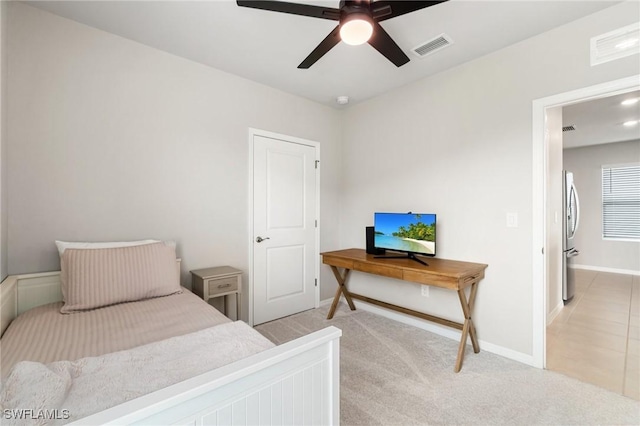 8833 Swell Brooks Ct, North Fort Myers, FL 33917 - bedroom featuring light colored carpet, freestanding refrigerator, baseboards, and ceiling fan