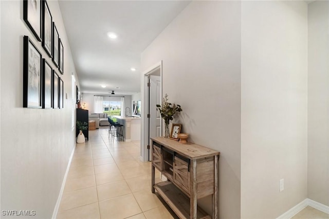 8833 Swell Brooks Ct, North Fort Myers, FL 33917 - hall featuring baseboards, light tile patterned flooring, and recessed lighting