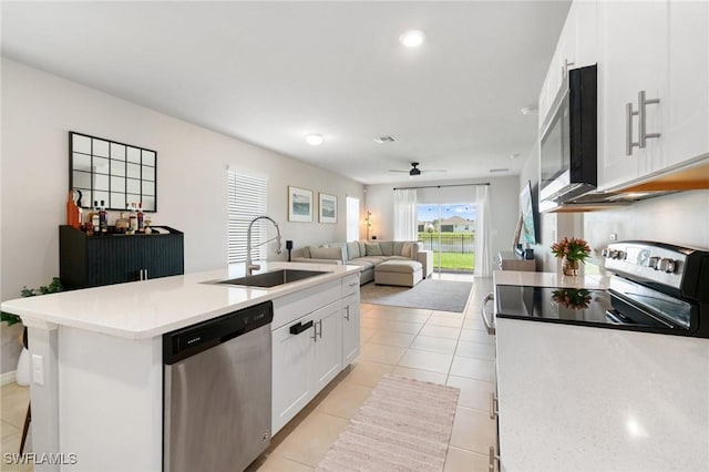 8833 Swell Brooks Ct, North Fort Myers, FL 33917 - kitchen featuring appliances with stainless steel finishes, a sink, white cabinetry, light tile patterned floors, and light countertops