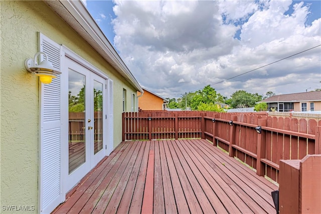 9091 Cypress Dr N, Fort Myers, FL 33967 - deck featuring french doors and a fenced backyard