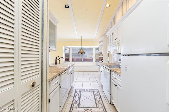 9091 Cypress Dr N, Fort Myers, FL 33967 - kitchen with white appliances, a sink, white cabinetry, light tile patterned floors, and pendant lighting