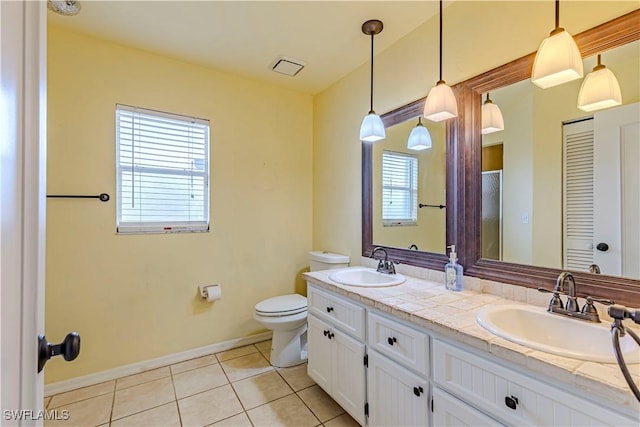 9091 Cypress Dr N, Fort Myers, FL 33967 - full bathroom with toilet, plenty of natural light, tile patterned flooring, and double vanity