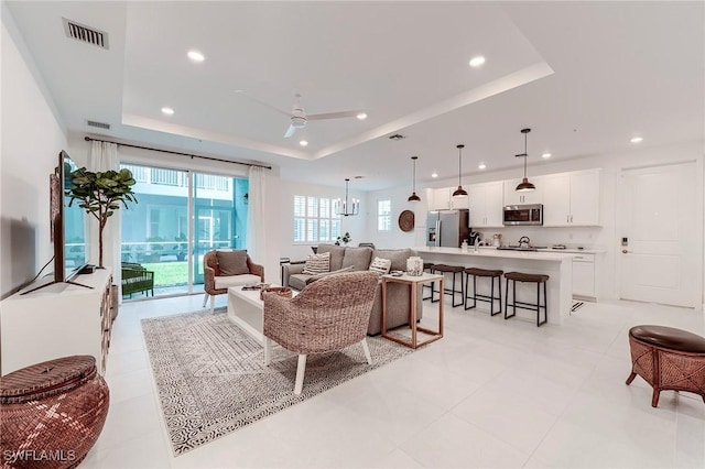 26401 Coco Cay Cir Unit 101, Bonita Springs, FL 34135 - living room featuring a raised ceiling, recessed lighting, ceiling fan, and light tile patterned flooring