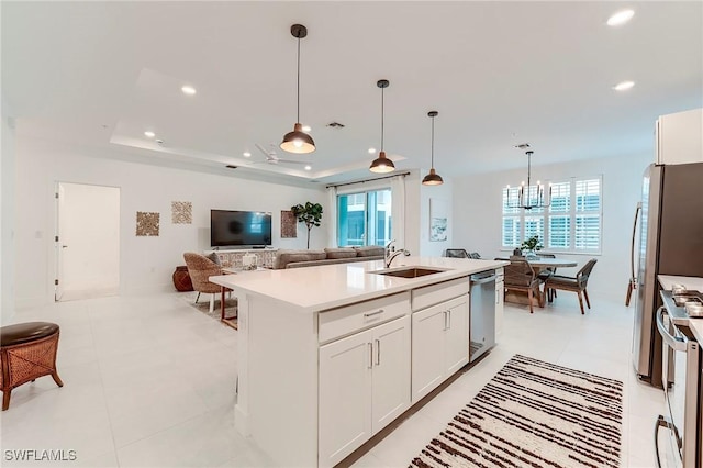 26401 Coco Cay Cir Unit 101, Bonita Springs, FL 34135 - kitchen featuring appliances with stainless steel finishes, a sink, a tray ceiling, light countertops, and white cabinetry