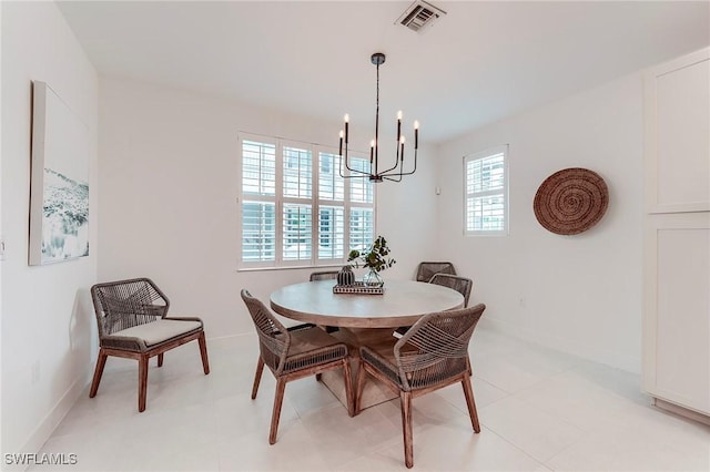 26401 Coco Cay Cir Unit 101, Bonita Springs, FL 34135 - dining room with a chandelier, healthy amount of natural light, and baseboards