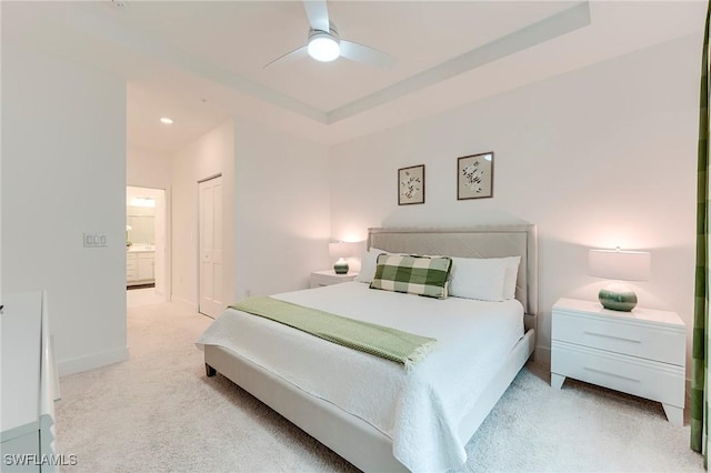 26401 Coco Cay Cir Unit 101, Bonita Springs, FL 34135 - carpeted bedroom with a closet, a ceiling fan, baseboards, ensuite bath, and a raised ceiling