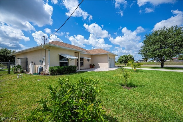 1115 Comet Ave, Labelle, FL 33935 - rear view of house with stucco siding and a garage