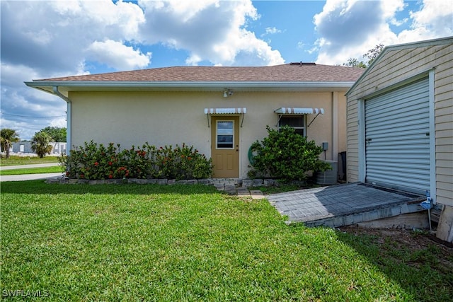 1115 Comet Ave, Labelle, FL 33935 - rear view of house with a lawn and stucco siding
