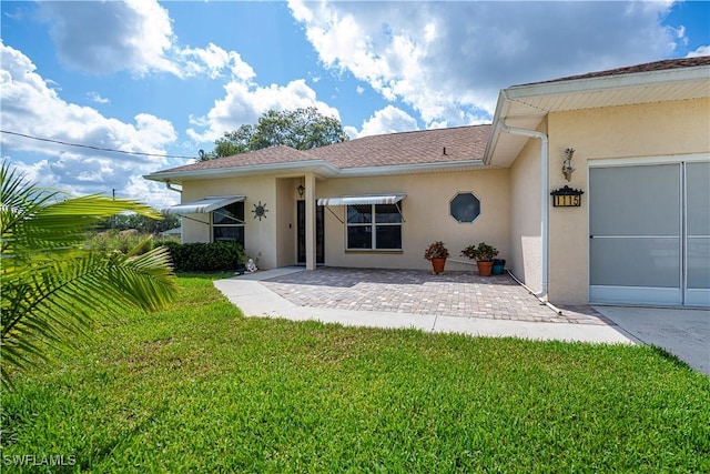1115 Comet Ave, Labelle, FL 33935 - back of property featuring stucco siding, a yard, and a patio