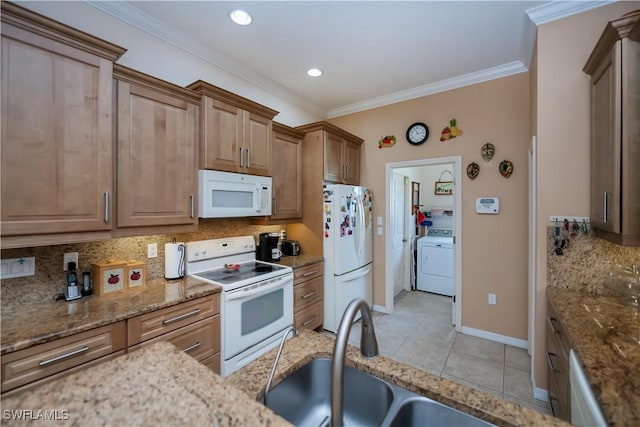 1115 Comet Ave, Labelle, FL 33935 - kitchen with white appliances, washer / dryer, tasteful backsplash, light stone countertops, and light tile patterned floors