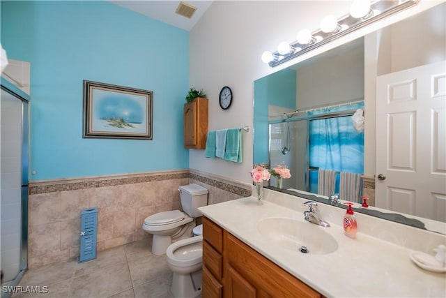 1115 Comet Ave, Labelle, FL 33935 - full bathroom featuring tile walls, tile patterned floors, a stall shower, toilet, and a bidet