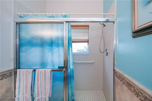1115 Comet Ave, Labelle, FL 33935 - full bathroom featuring a stall shower, wainscoting, and tile walls