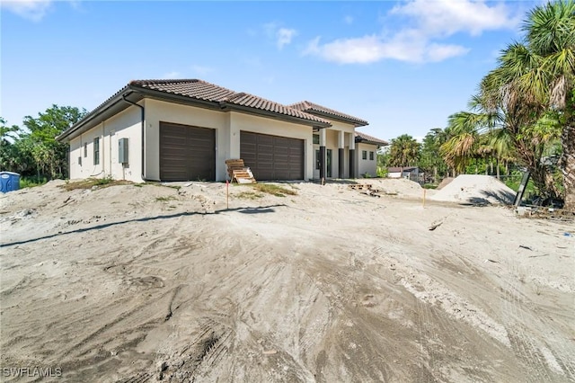 721 Golden Gate Blvd W, Naples, FL 34120 - view of front facade featuring a garage, stucco siding, and a tile roof