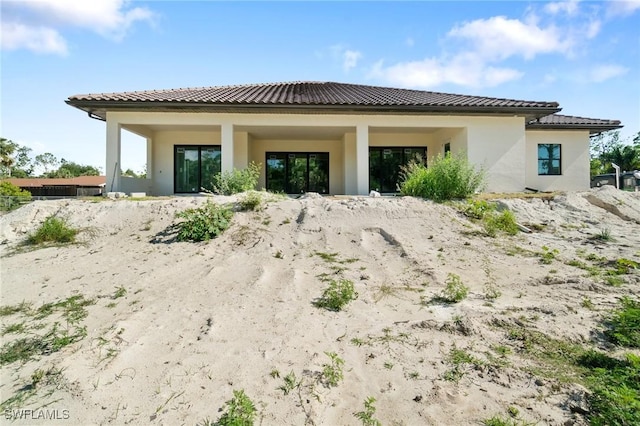 721 Golden Gate Blvd W, Naples, FL 34120 - back of house featuring stucco siding and a tiled roof