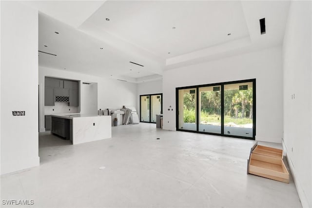721 Golden Gate Blvd W, Naples, FL 34120 - unfurnished living room with a tray ceiling and a high ceiling