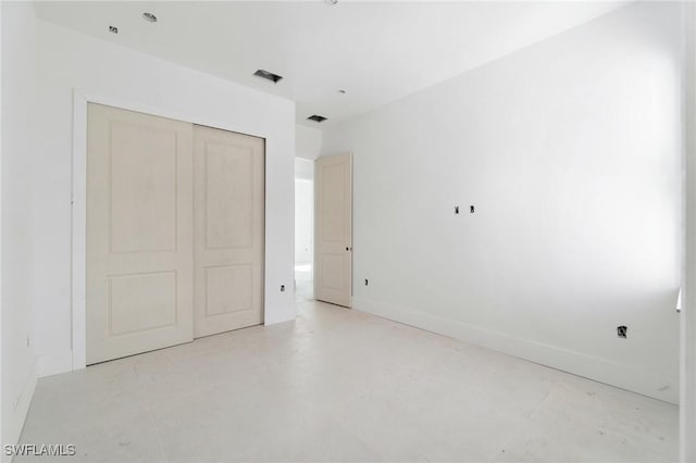 721 Golden Gate Blvd W, Naples, FL 34120 - unfurnished bedroom featuring a closet, concrete flooring, and baseboards