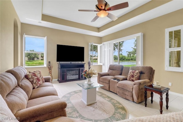 3032 Lake Manatee Ct, Cape Coral, FL 33909 - living area featuring healthy amount of natural light, a tray ceiling, and light tile patterned flooring