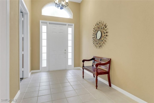 3032 Lake Manatee Ct, Cape Coral, FL 33909 - entrance foyer with light tile patterned floors, baseboards, and a chandelier