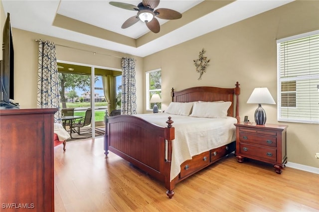 3032 Lake Manatee Ct, Cape Coral, FL 33909 - bedroom with access to outside, light wood-type flooring, a raised ceiling, and baseboards