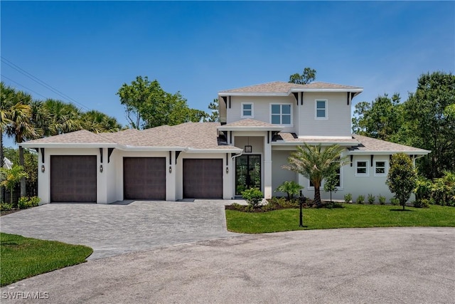 2854 Coach House Way, Naples, FL 34105 - view of front of property with decorative driveway, a garage, a front yard, stucco siding, and roof with shingles