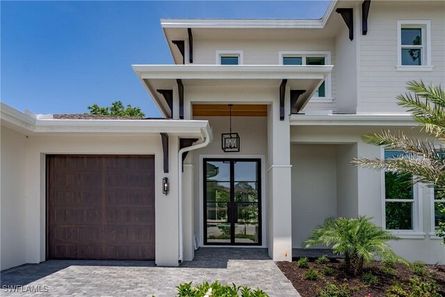 2854 Coach House Way, Naples, FL 34105 - doorway to property featuring stucco siding and driveway