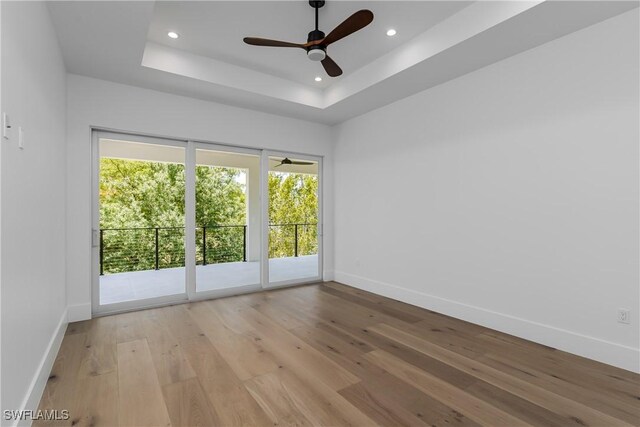 2854 Coach House Way, Naples, FL 34105 - unfurnished room with baseboards, recessed lighting, light wood-style flooring, a ceiling fan, and a raised ceiling