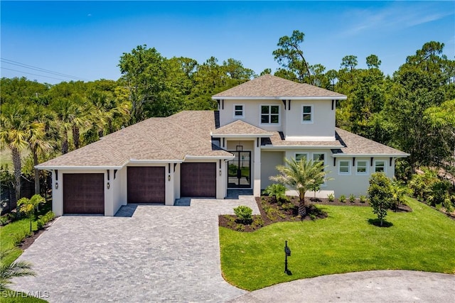 2854 Coach House Way, Naples, FL 34105 - view of front of house with an attached garage, decorative driveway, a front lawn, and a shingled roof