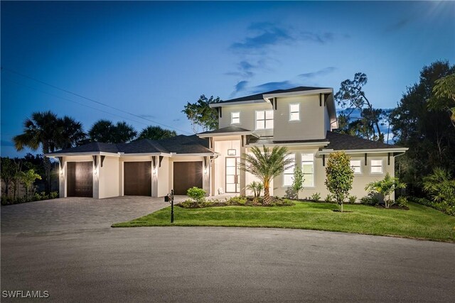 2854 Coach House Way, Naples, FL 34105 - view of front of home featuring decorative driveway, a garage, a front yard, and stucco siding
