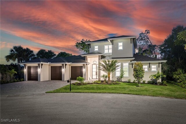 2854 Coach House Way, Naples, FL 34105 - view of front facade featuring decorative driveway, an attached garage, a front lawn, and stucco siding