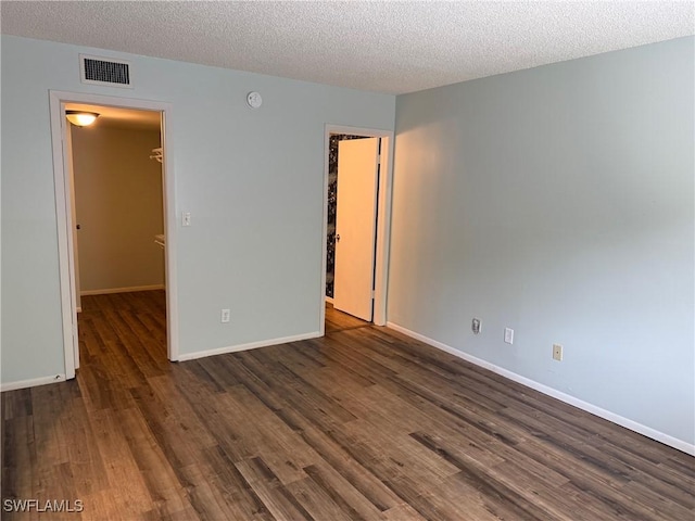 5499 Rattlesnake Hammock Rd Unit A 103, Naples, FL 34113 - unfurnished room with dark wood finished floors, a textured ceiling, baseboards, and a smoke detector