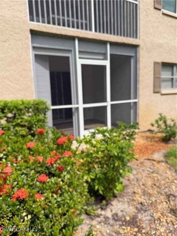 5499 Rattlesnake Hammock Rd Unit A 103, Naples, FL 34113 - view of home's exterior featuring stucco siding and a balcony