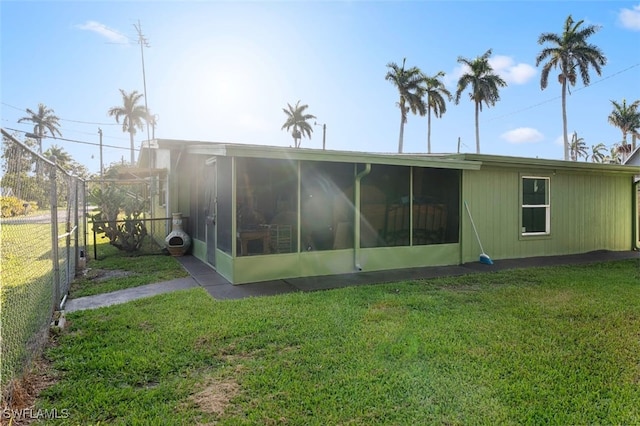 1154 4th Way N, Fort Myers, FL 33903 - rear view of property with a sunroom