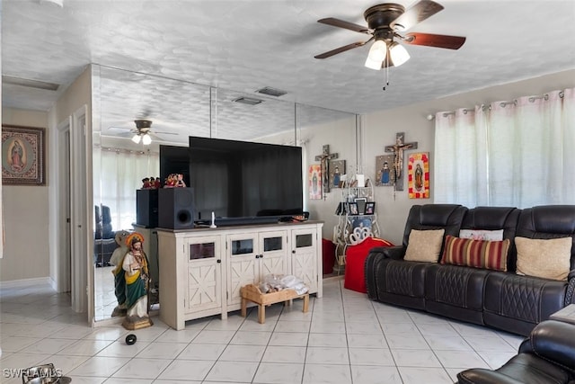 1154 4th Way N, Fort Myers, FL 33903 - living room featuring ceiling fan, a textured ceiling, light tile patterned floors, and baseboards