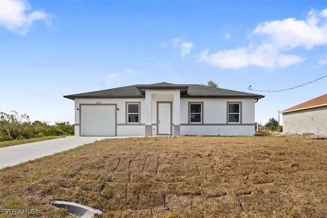 2902 61st St W, Lehigh Acres, FL 33971 - prairie-style home with concrete driveway, an attached garage, stucco siding, and a shingled roof