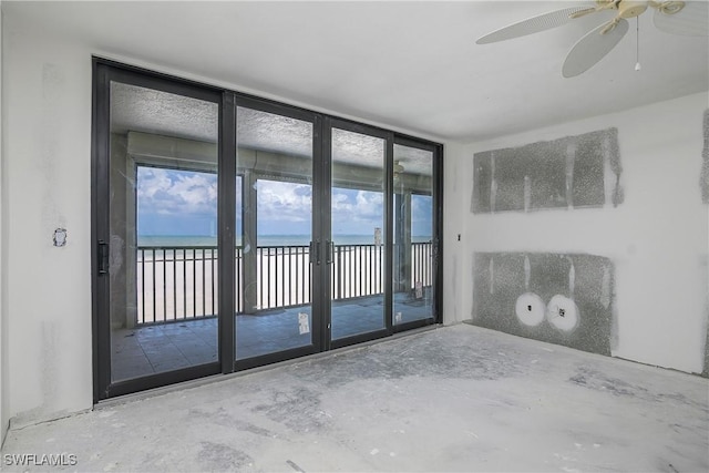 538 Estero Blvd Unit 102, Fort Myers Beach, FL 33931 - unfurnished room with a water view, a ceiling fan, and unfinished concrete floors