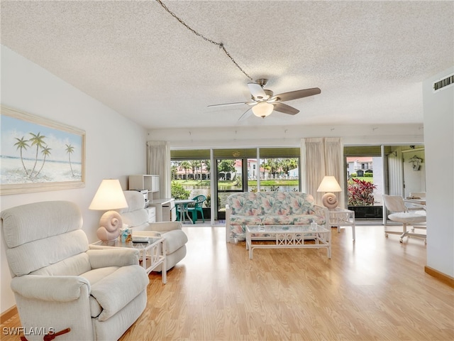 5479 Peppertree Dr Unit 13, Fort Myers, FL 33908 - living room with plenty of natural light, wood finished floors, ceiling fan, and a textured ceiling