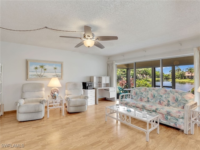 5479 Peppertree Dr Unit 13, Fort Myers, FL 33908 - living room with a textured ceiling, a water view, a ceiling fan, and wood finished floors
