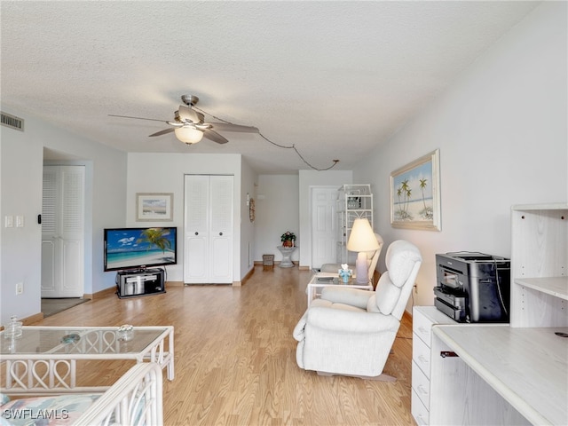 5479 Peppertree Dr Unit 13, Fort Myers, FL 33908 - living area featuring ceiling fan, light wood-style floors, a textured ceiling, and baseboards
