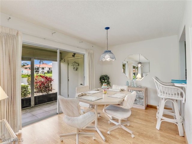 5479 Peppertree Dr Unit 13, Fort Myers, FL 33908 - dining area with wood finished floors and a textured ceiling