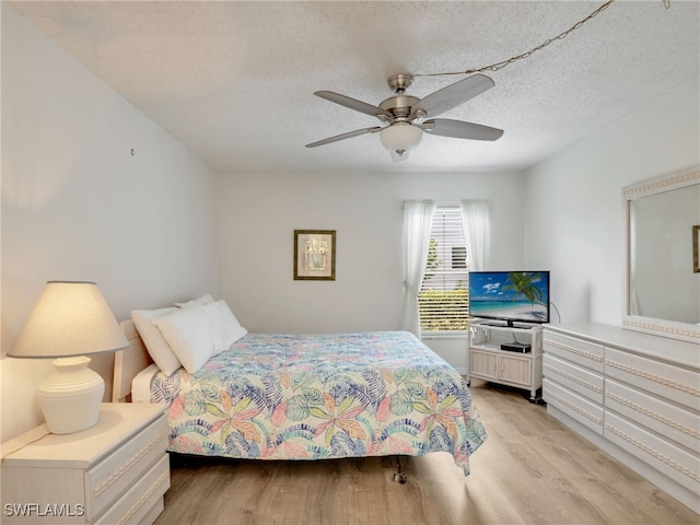 5479 Peppertree Dr Unit 13, Fort Myers, FL 33908 - bedroom with light wood-style floors, a textured ceiling, and ceiling fan