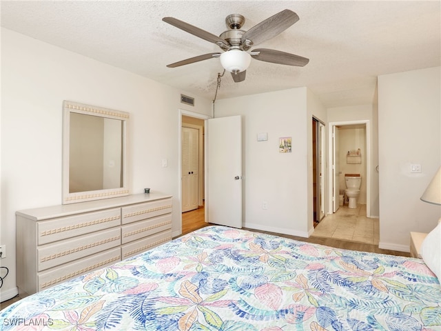 5479 Peppertree Dr Unit 13, Fort Myers, FL 33908 - bedroom with a textured ceiling, ensuite bath, baseboards, and a ceiling fan