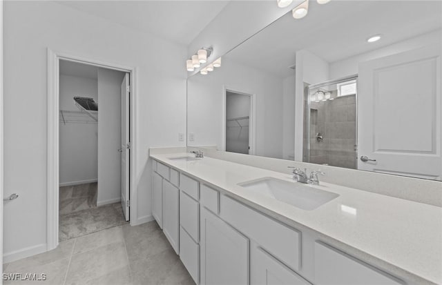 44225 Kelly Dr, Punta Gorda, FL 33982 - bathroom featuring double vanity, a walk in closet, tiled shower, and baseboards