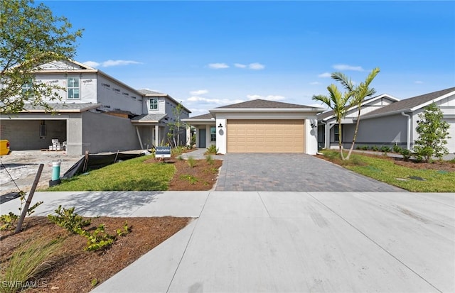 44225 Kelly Dr, Punta Gorda, FL 33982 - view of front of home featuring decorative driveway, a garage, and stucco siding